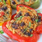 Plate of black bean and quinoa stuffed peppers with a fork