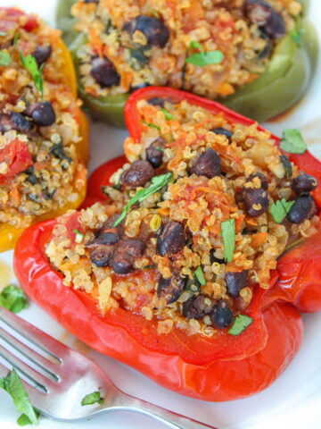 Plate of black bean and quinoa stuffed peppers with a fork