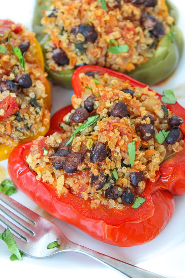 Plate of black bean and quinoa stuffed peppers with a fork