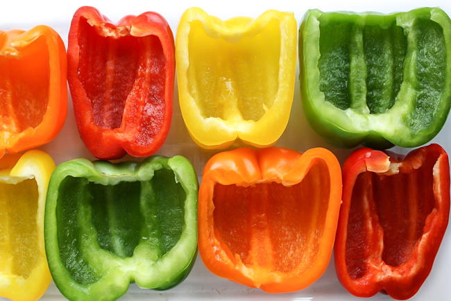 colorful bell pepper halves sitting open faced on a pan