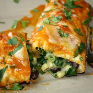 Black Bean Spinach Enchiladas on a plate with fork