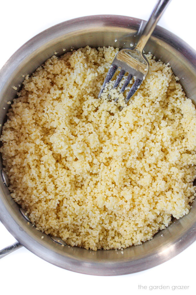 Fluffed couscous cooking in a small saucepan