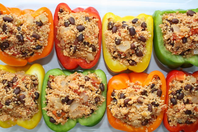 Pan of couscous stuffed bell peppers with black beans