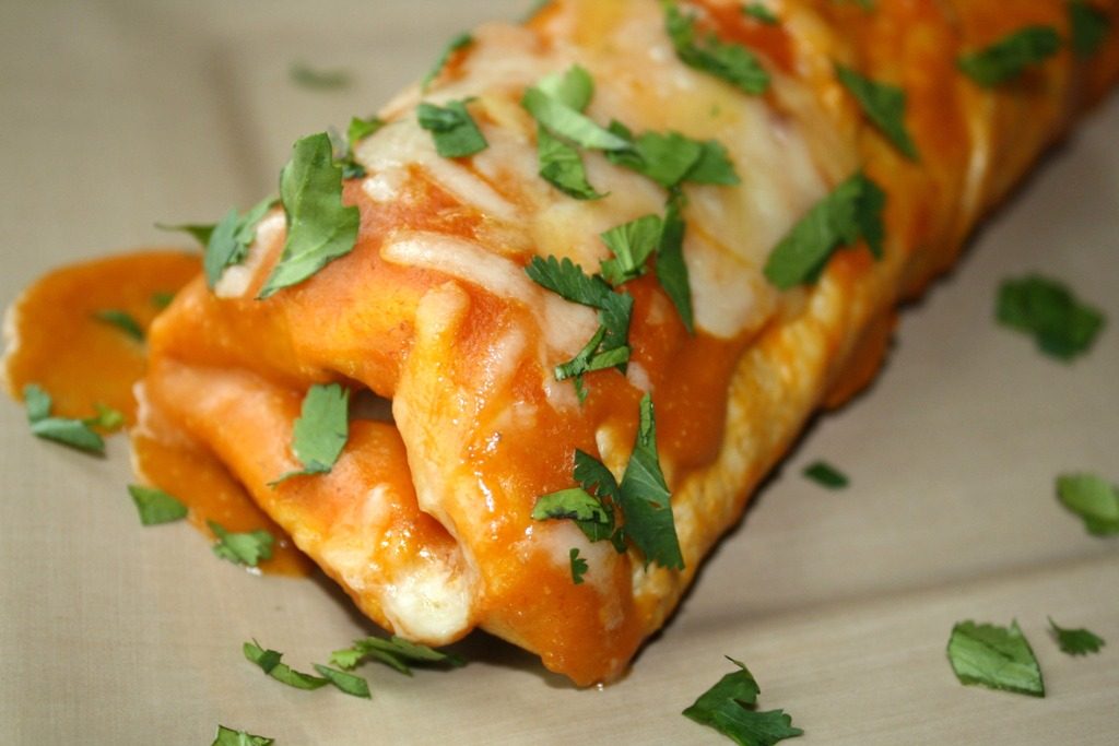 Vegan Black Bean Spinach Enchiladas with homemade enchilada sauce on a plate