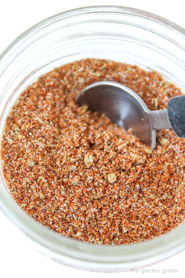 Homemade spice blend in a small jar with teaspoon