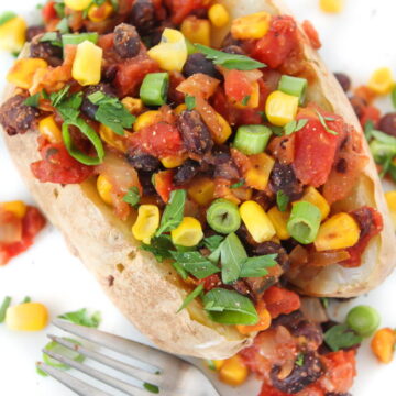 Vegan Mexican style baked potato on a plate with fork