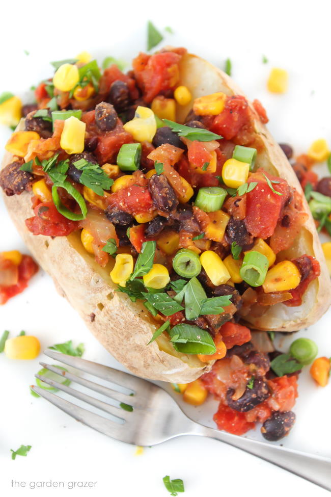 Vegan Mexican style baked potato on a plate with fork