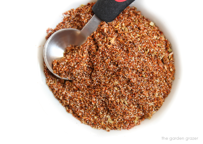homemade taco seasoning in a bowl with teaspoon