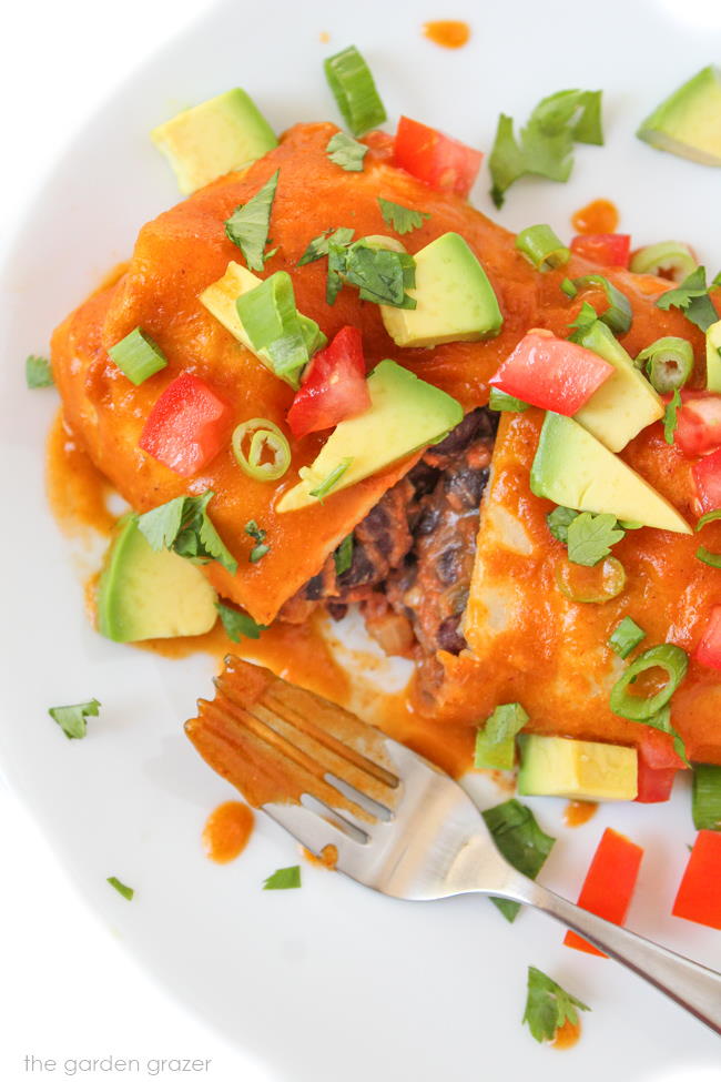 Vegan bean enchilada on a plate with fork