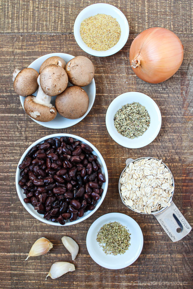 Beans, oats, onion, garlic, and spices on a wooden table