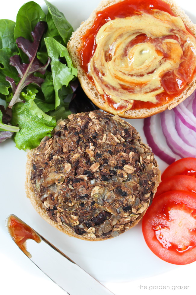 Baked black bean mushroom burger patty on a bun on a white plate