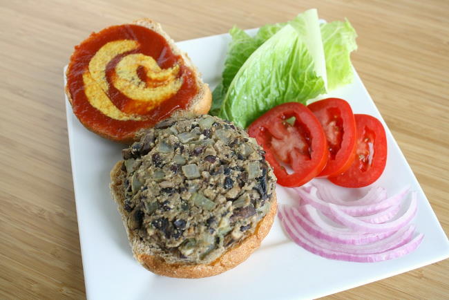 Vegan black bean mushroom burger on a bun with toppings