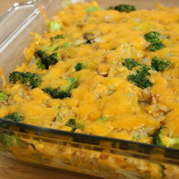 Broccoli Quinoa Casserole topped with vegan cheese in a pan