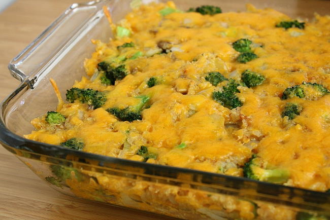 Cooked Broccoli Quinoa Casserole topped with vegan cheese in a pan