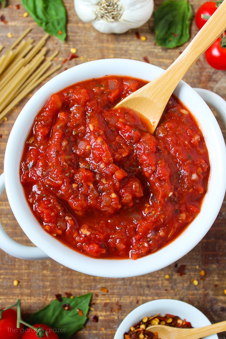Close up view of vegan marinara sauce in a white serving bowl