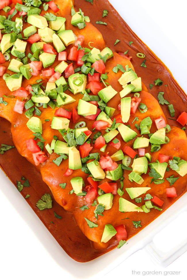 Bean enchiladas in a pan with homemade enchilada sauce