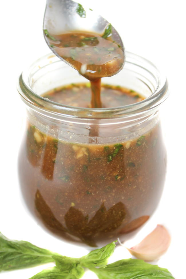 Jar of oil-free basil balsamic dressing with garlic