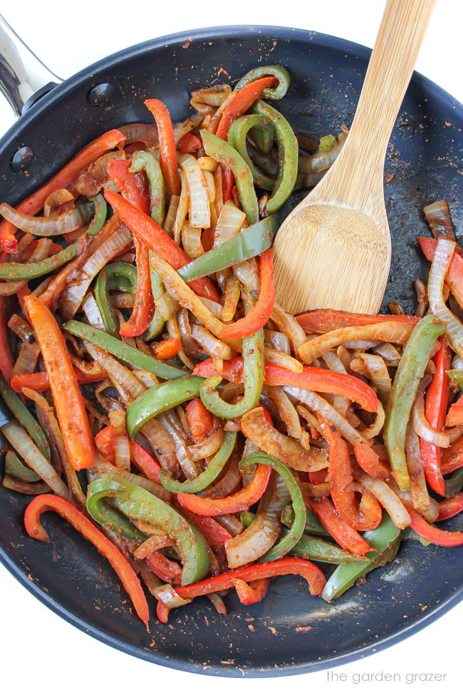 Bell pepper and onions cooking in a pan