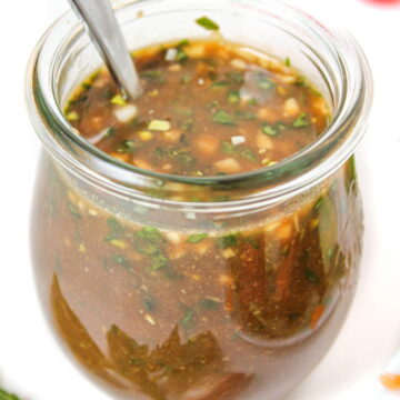 Oil-free garlic basil balsamic dressing in a small jar with spoon