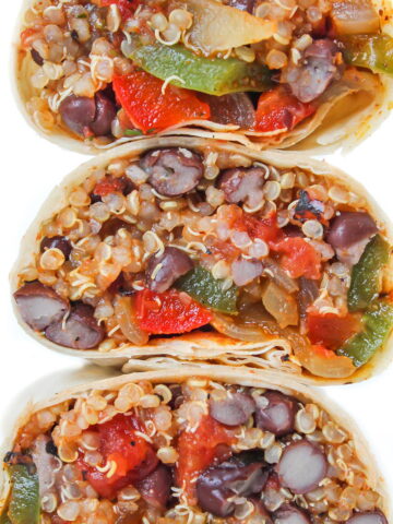 Stacked quinoa burritos with black beans and veggies