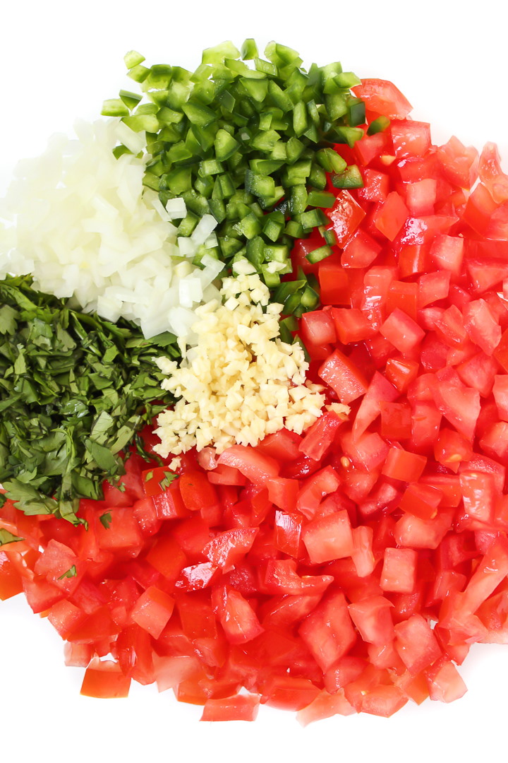 Chopped tomato, cilantro, onion, and jalapeno in a bowl