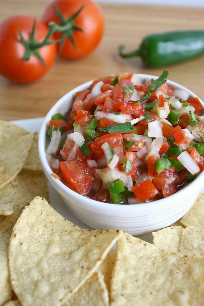 Fresh pico de gallo in a bowl with chips for dipping