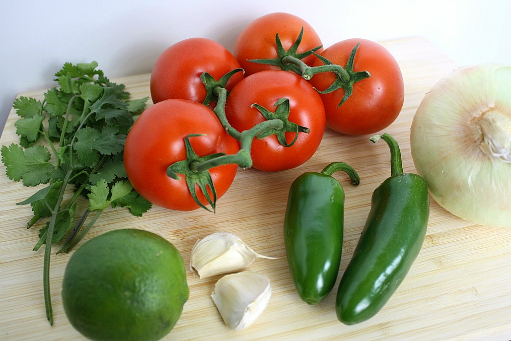 Ingredients on a cutting board for fresh salsa fresca