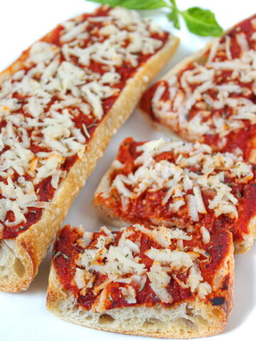 Vegan French bread pizza on a white plate