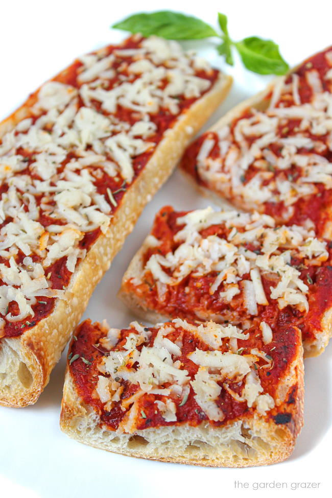 Vegan French bread pizza on a white plate