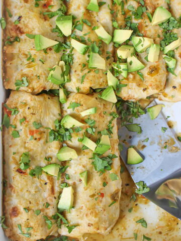 Vegan green enchiladas in a white baking dish