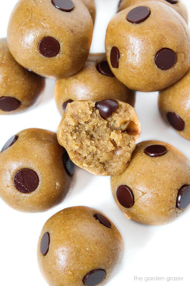 Healthy cookie dough bites on a white plate with one broken half open