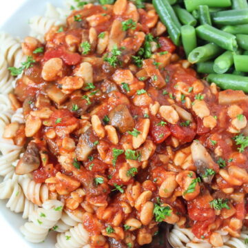 Plate of tempeh mushroom pasta with green beans