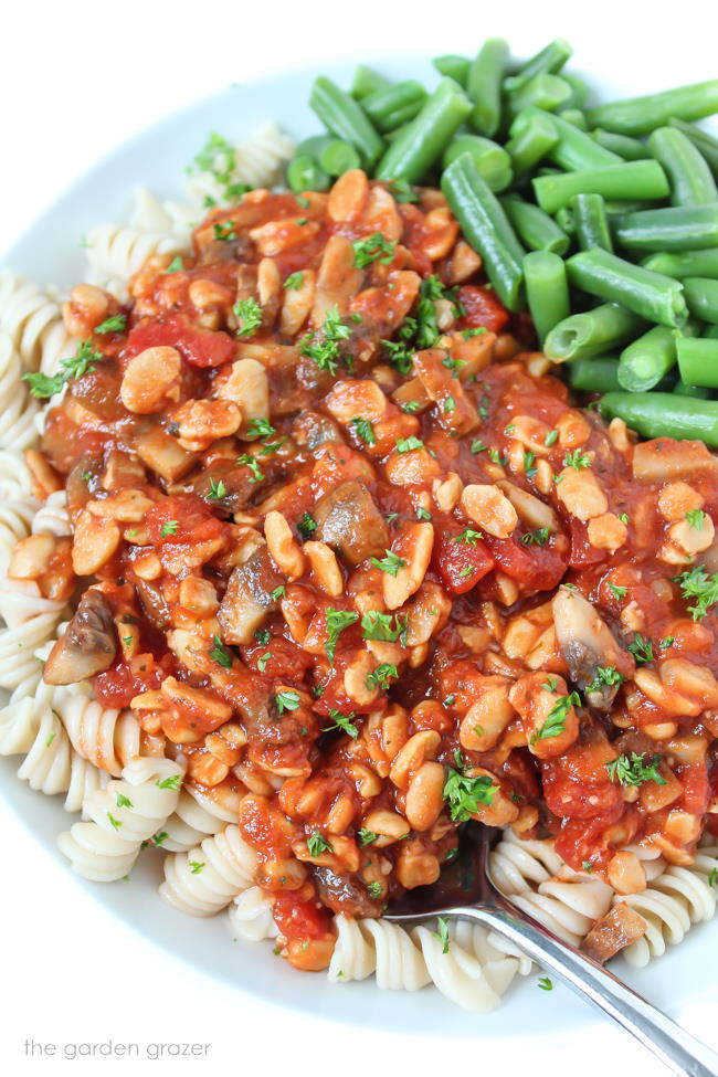 Plate of tempeh mushroom pasta with green beans