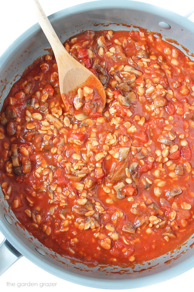 Pan of mushroom tempeh pasta sauce with spoon
