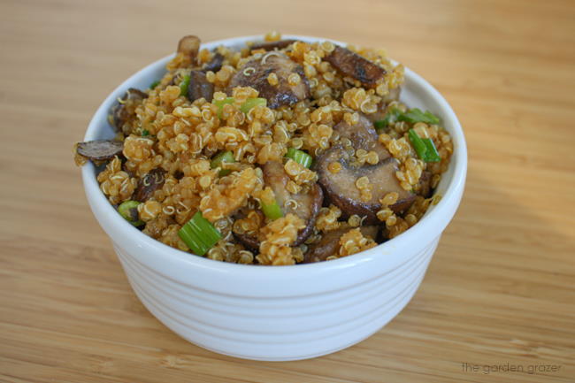 Small white bowl filled with Asian-style toasted quinoa and mushrooms