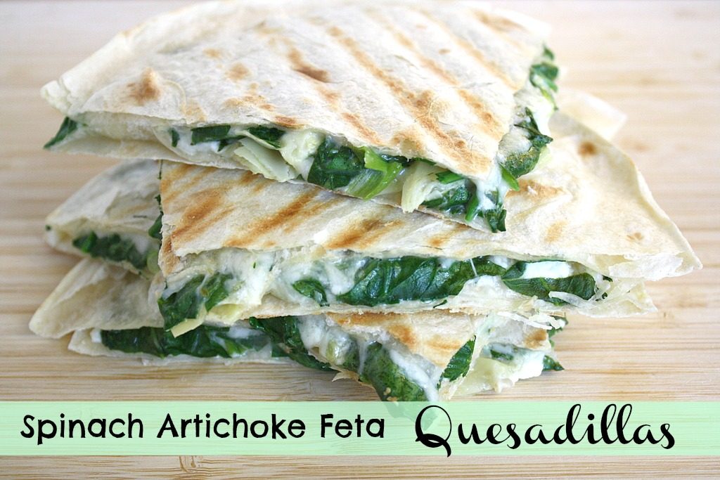 Spinach artichoke quesadillas cut in half on a cutting board