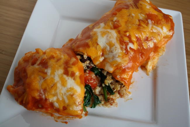 Vegetable quinoa enchilada with homemade sauce on a white plate