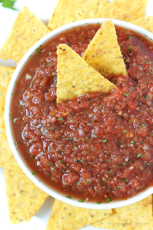 Restaurant-style blender salsa in a small white bowl with tortilla chips