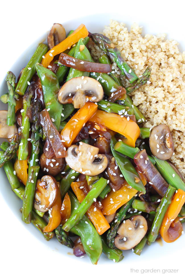 Bowl of quinoa vegetable stir fry with sesame seeds