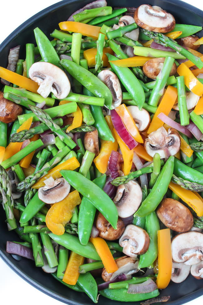 Mixed vegetables cooking in a large skillet
