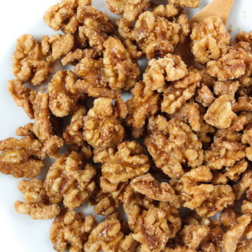 Healthy candied nuts with maple syrup on a white plate