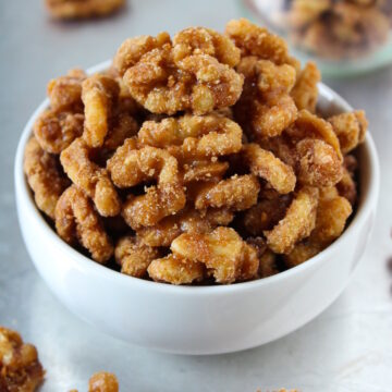 Maple vanilla candied nuts in a small white serving bowl
