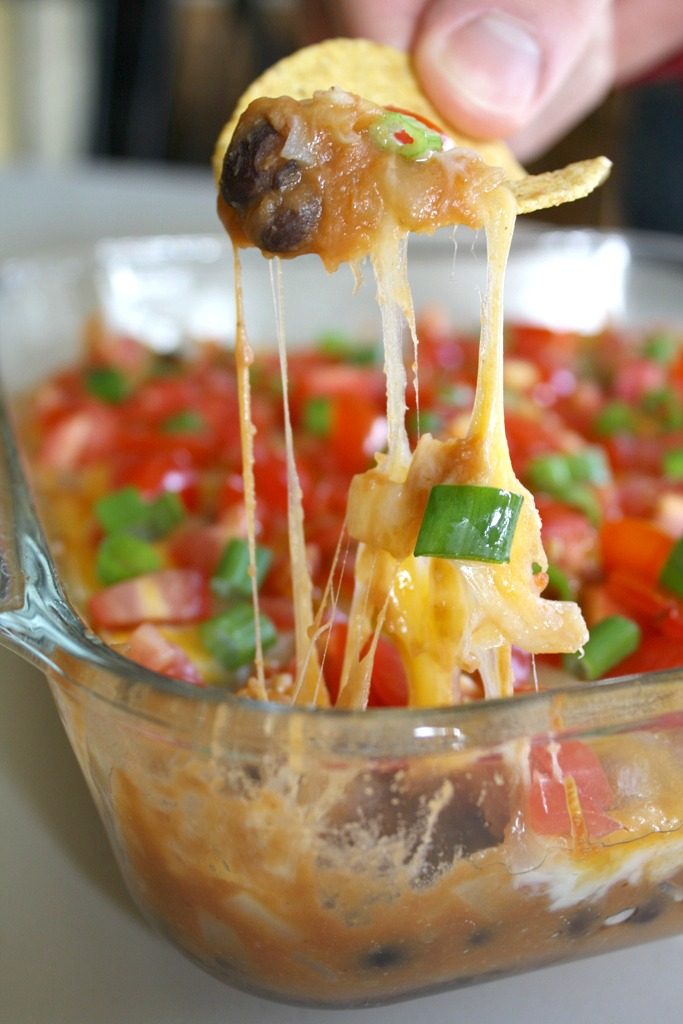 Tortilla chip dipping into beans