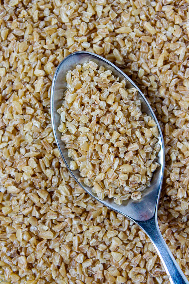 Close up view of bulgur ingredient with metal spoon
