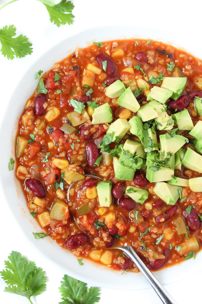 Bowl of chili topped with avocado and fresh cilantro