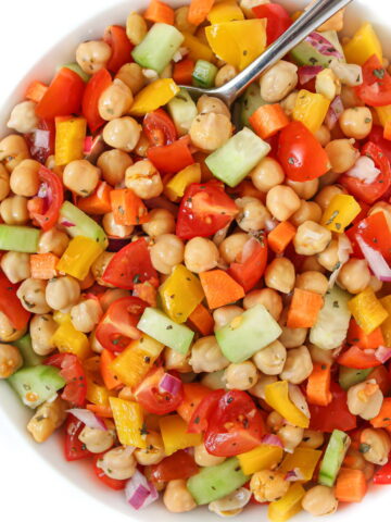 Chickpea vegetable salad in a white bowl