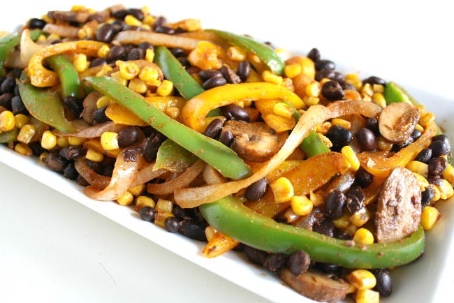 Plate of black bean fajitas with bell pepper, mushrooms and corn