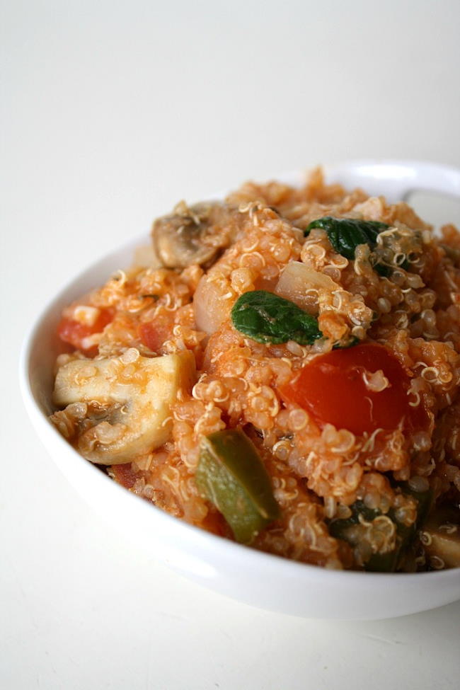 Vegan vegetable supreme pizza quinoa casserole in a small white bowl