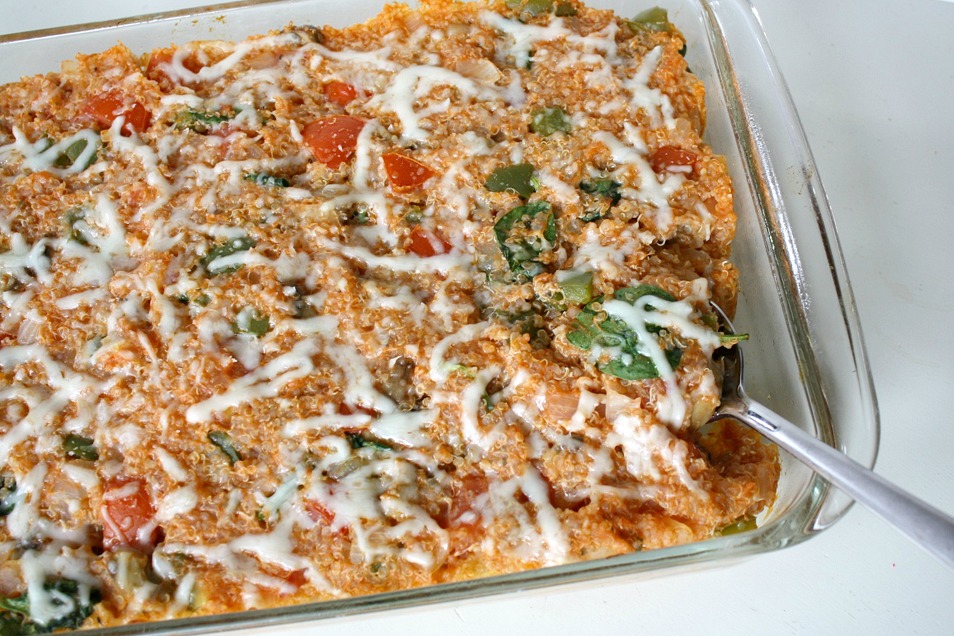Vegan pizza quinoa casserole in a large pan with spoon