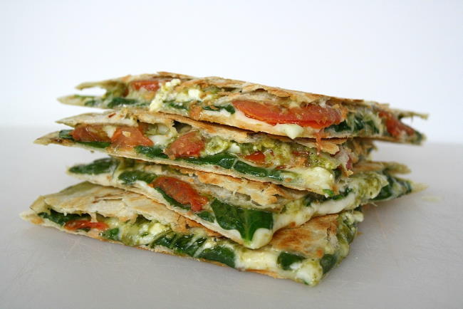 Vegan pesto quesadillas on a cutting board